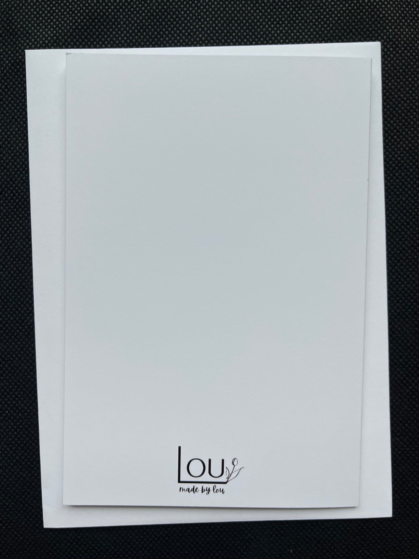 White card with 'LOU' branding on a black textured background